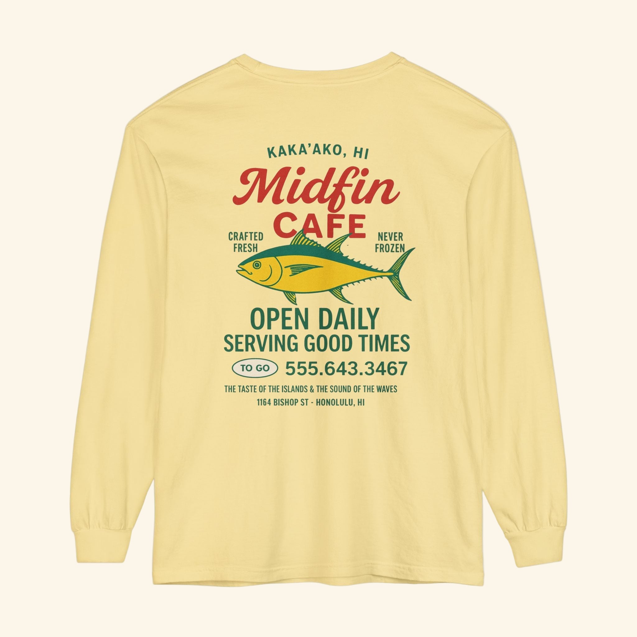 Yellow long-sleeve shirt with Midfin Cafe branding and fish graphic on a white background