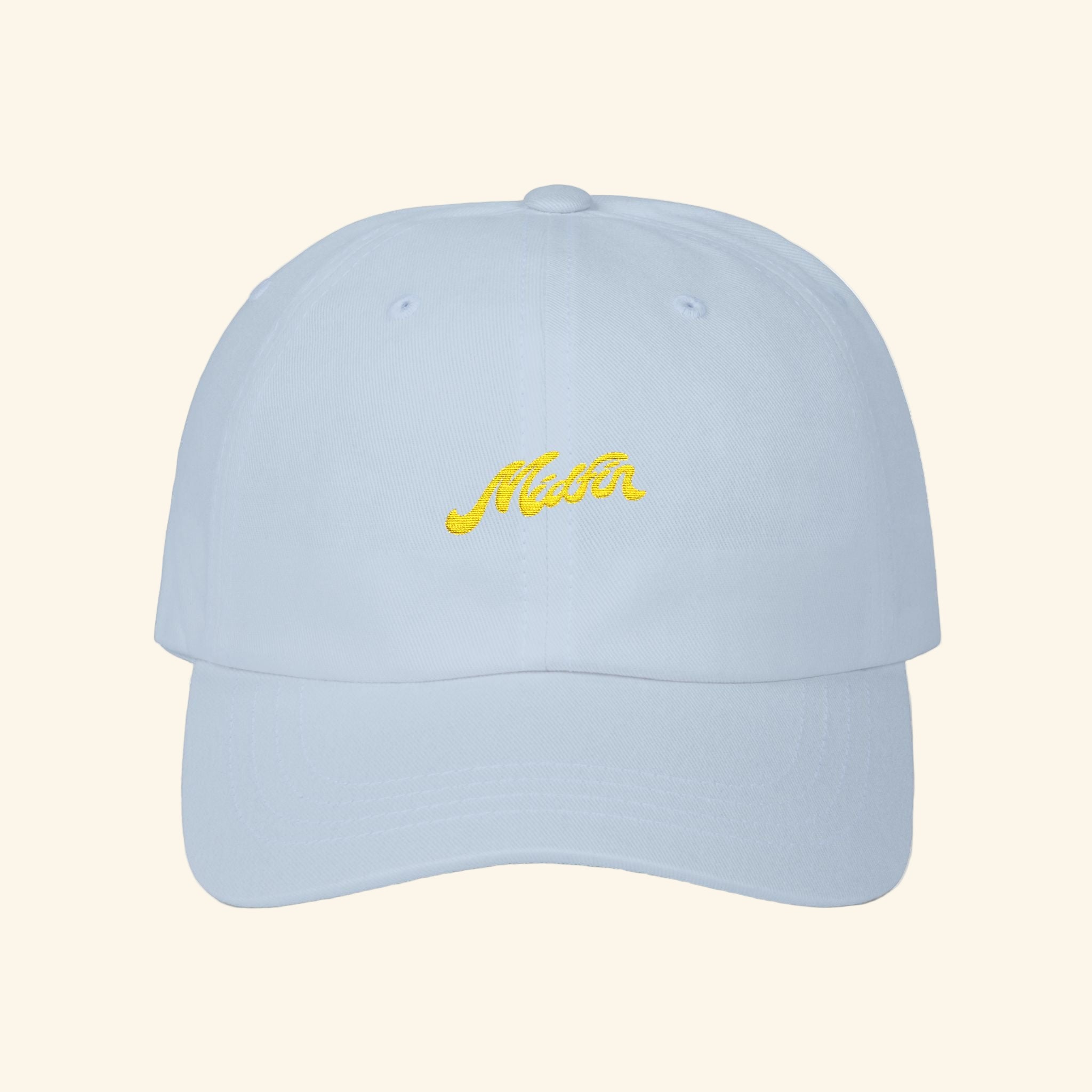 Light blue cap with yellow text on a white background