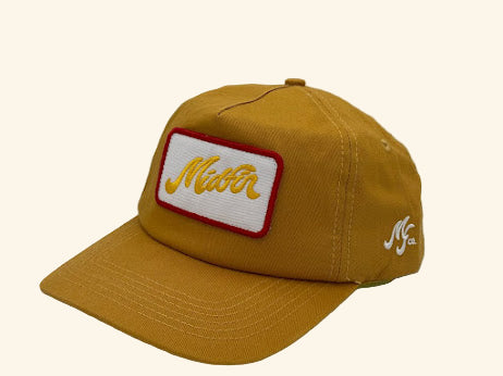 Yellow cap with a red and white logo on a gray background