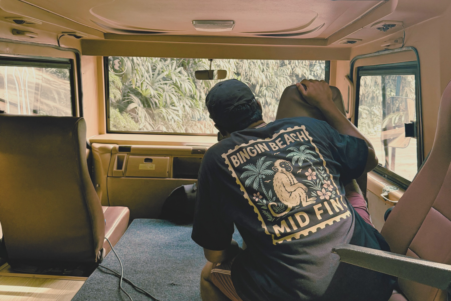 Person sitting inside a van with a scenic view outside